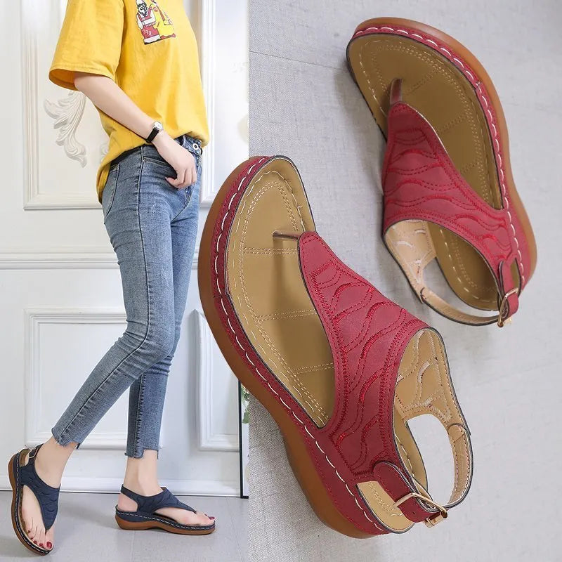 Women's solid colour wedge heel flip flop sandals with an adjustable buckle strap.