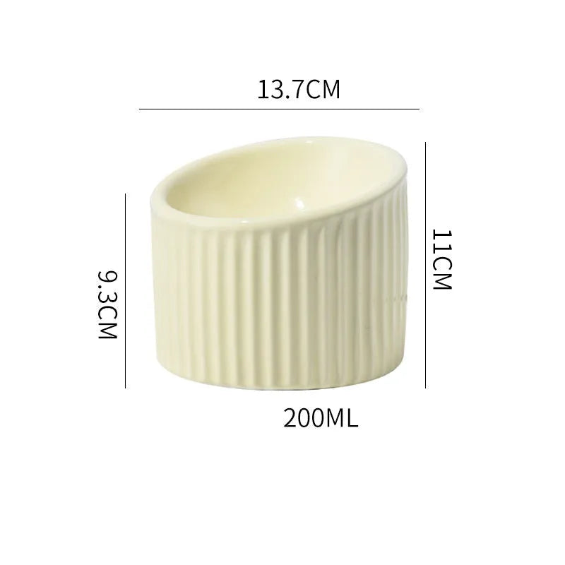 Ceramic elevated cat bowl in green colour with tilted round design for comfortable feeding.