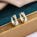 Geometric copper earrings with zircon treatment in 14K yellow colour, showing structured design and clean lines