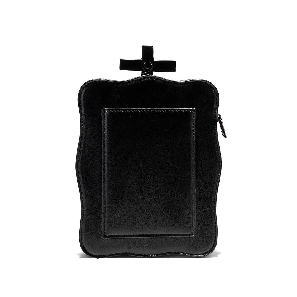 Black gothic crossbody bag with skull design, stitching, rivets, and chain details.