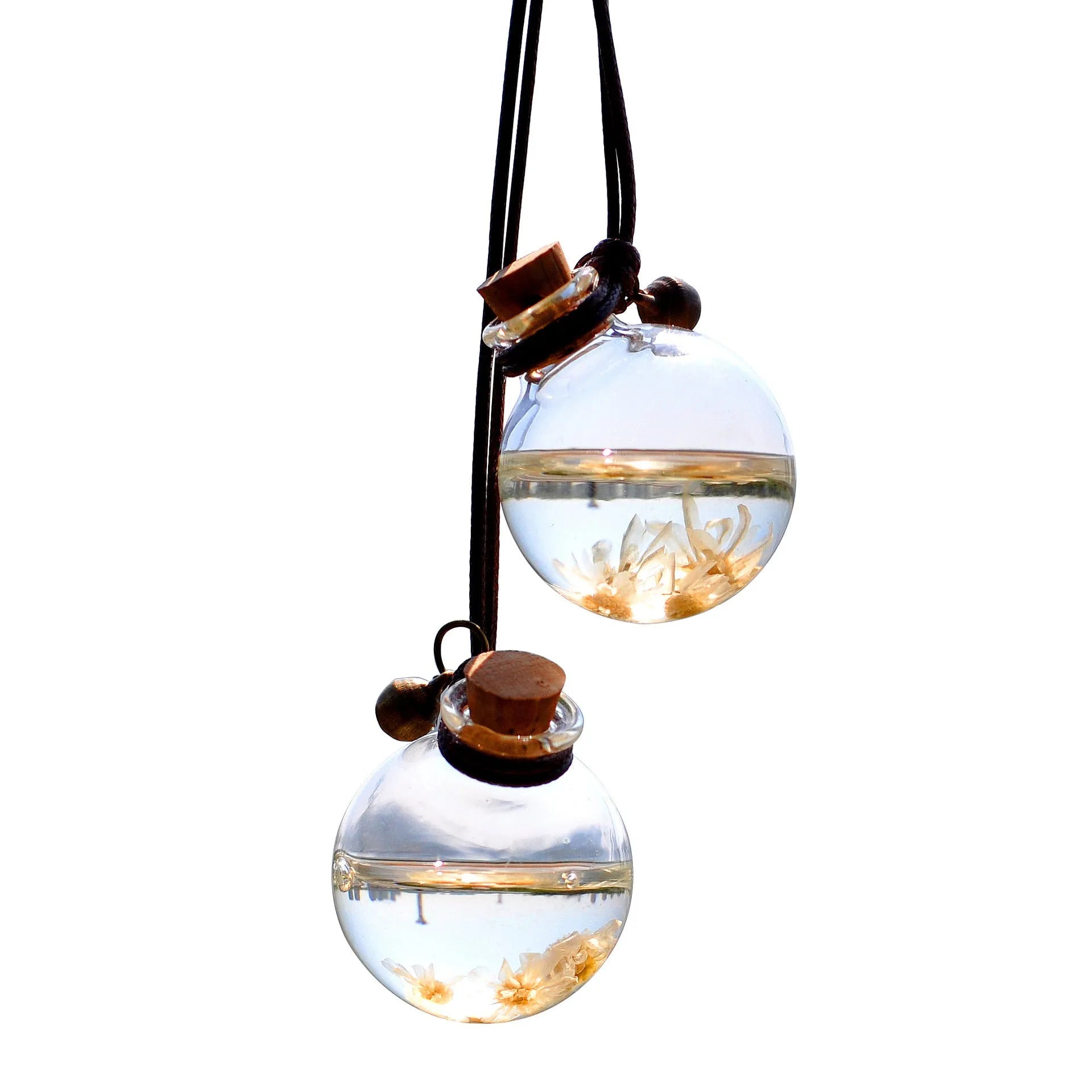 Glass car perfume pendant with preserved flower decoration hanging in car interior