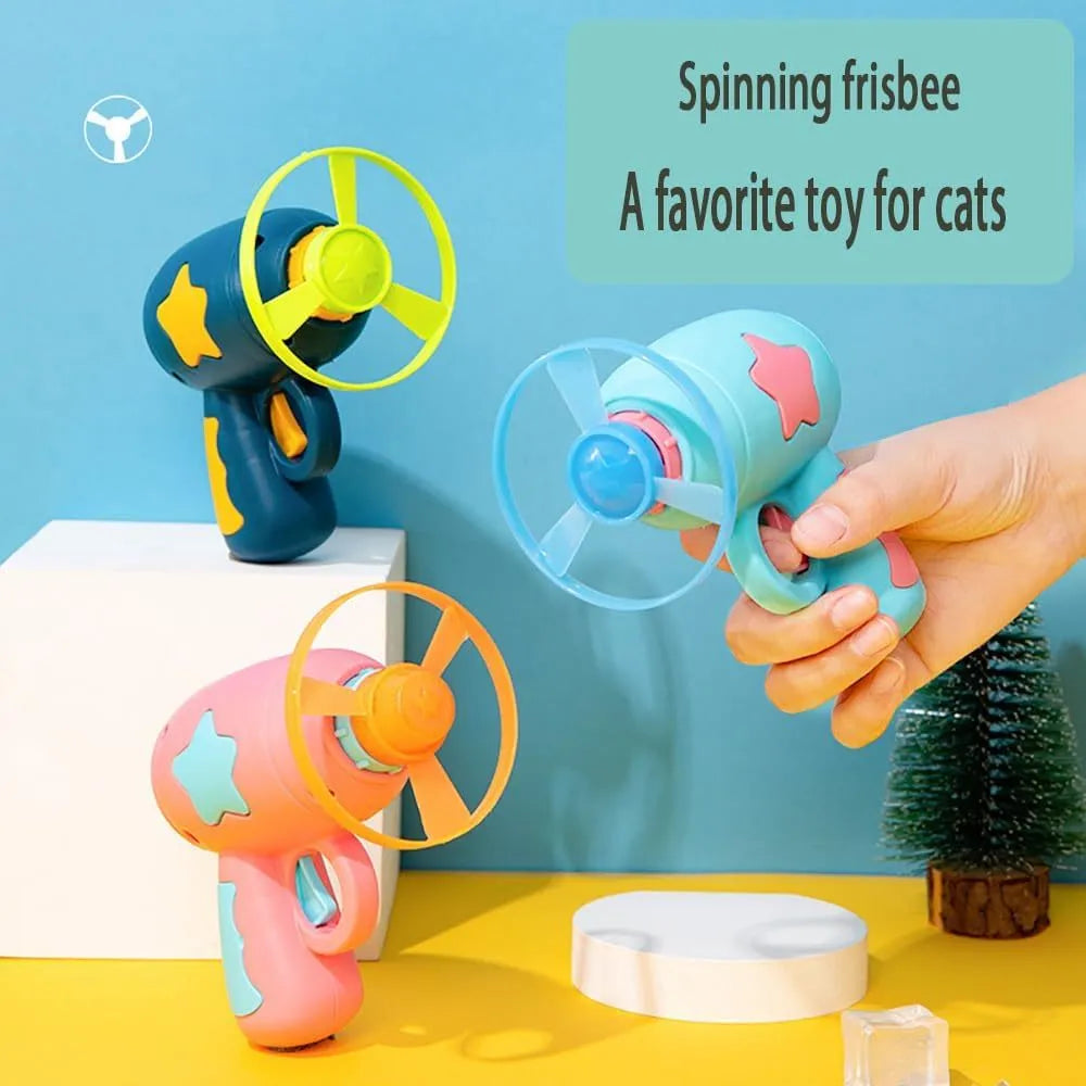Blue interactive cat toy gun with plastic Frisbee on launch mechanism for indoor hunting play