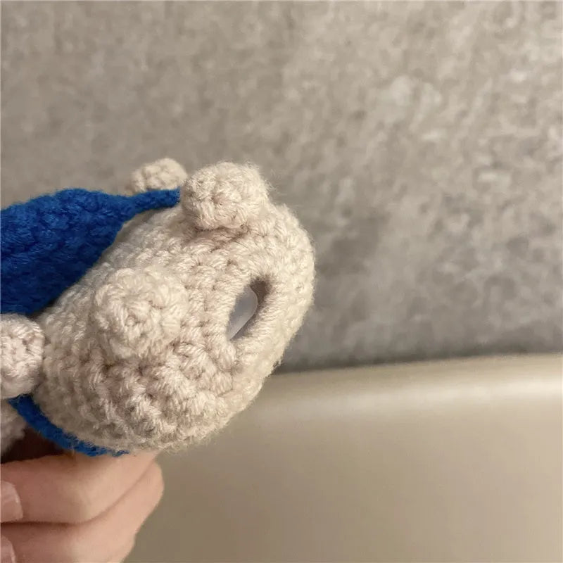 Hand knitted AirPods protective sleeve with koala bear backpack design on Apple AirPods case