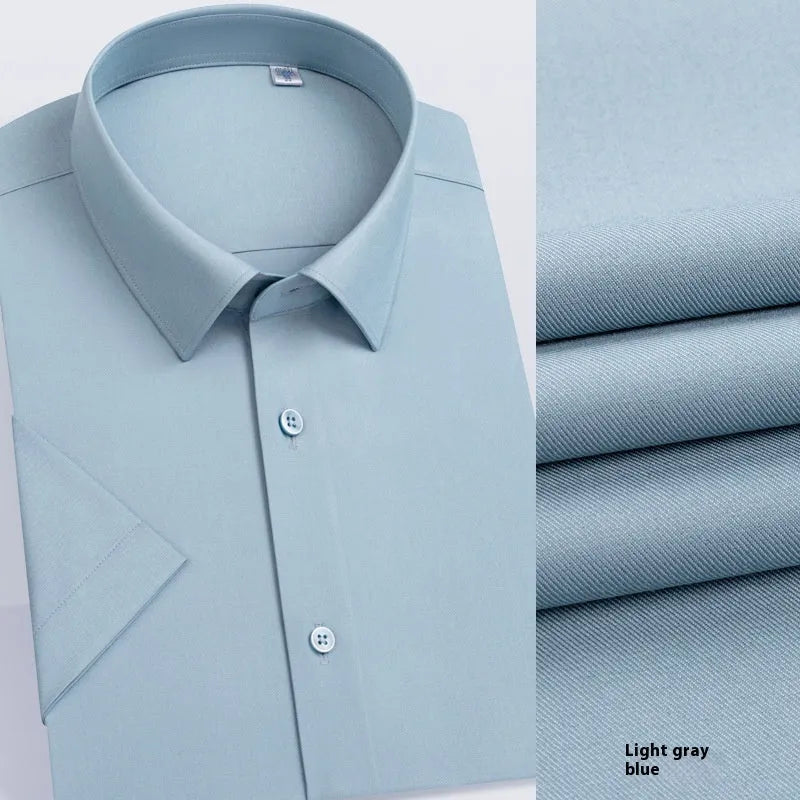 Man wearing a light blue long-sleeved non-iron business casual shirt with a regular fit.
