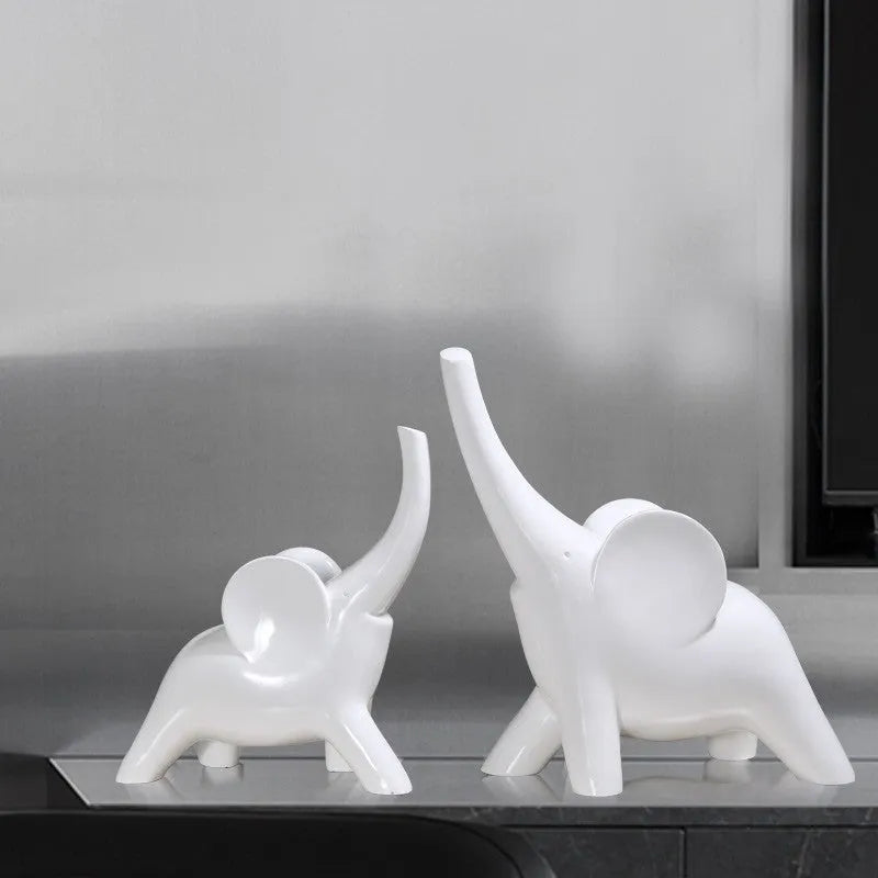 Modern resin elephant ornament in rose gold colour with raised trunk on display surface