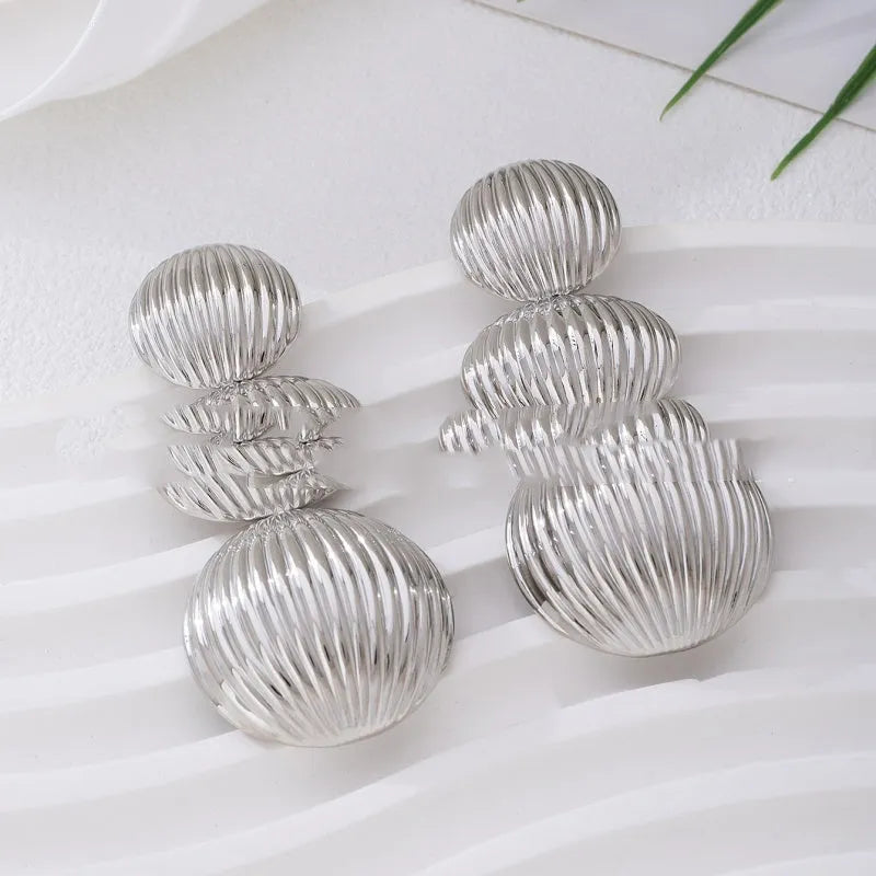 Retro women's polka dot metal bead drop earrings in frosted gold finish on a neutral background