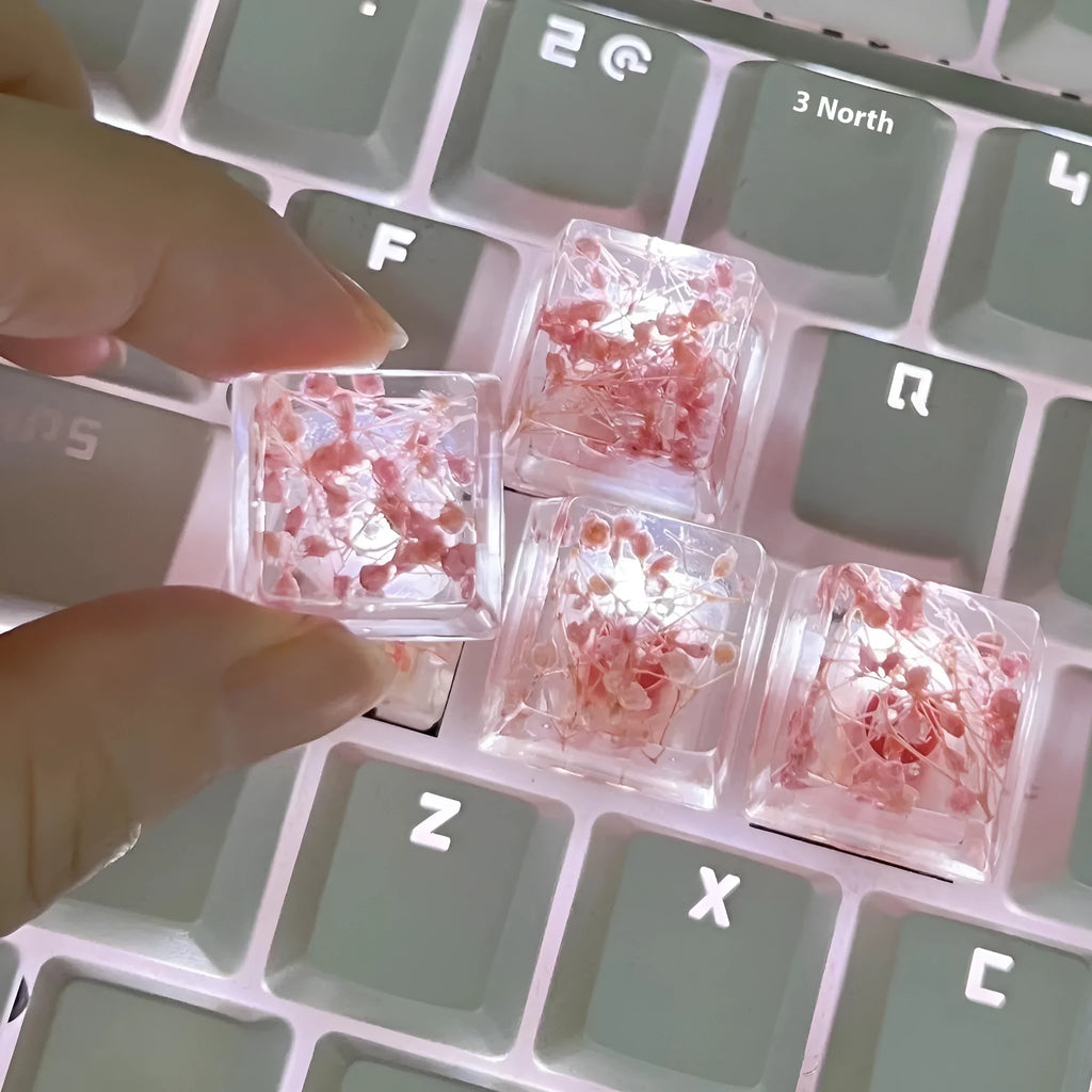 Transparent resin mechanical keyboard keycap with starry sky pattern in red, pink, green, and violet colour options