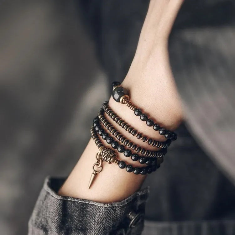 Black geometric patterned beaded bracelet with multi-layered natural materials design