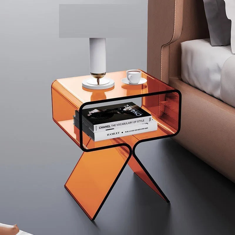 Minimalist acrylic side table in transparent black, 39x30x45cm, beside a sofa in a living room