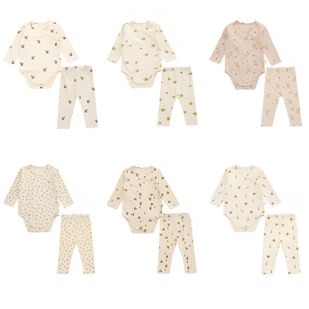 Newborn baby cotton romper two-piece suit in neutral style with top, pants, and matching hat on a white background