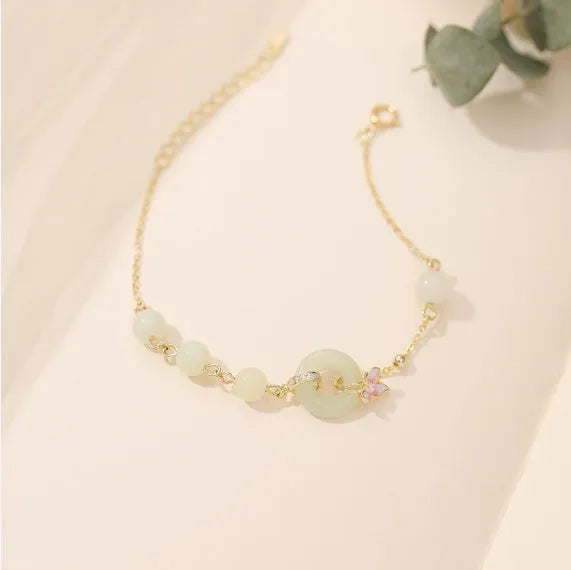 Sterling silver orchid necklace on a model, showing the floral pendant and peace buckle clasp.