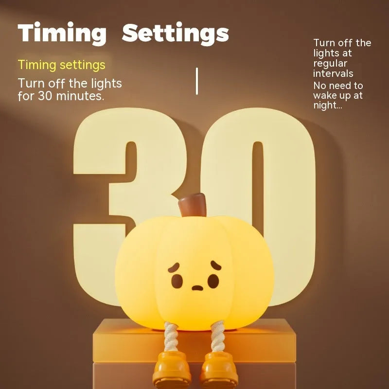 Soft orange pumpkin-shaped silicone night light with a warm glow, showing its compact size on a table.