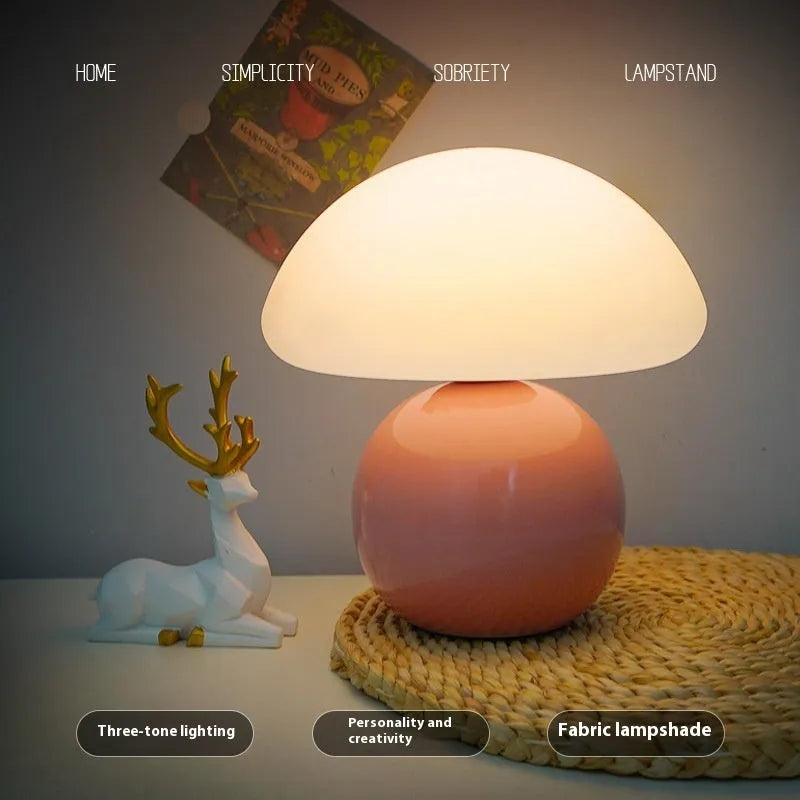 Cream ceramic mushroom table lamp with USB power cord on a bedside table, available in yellow