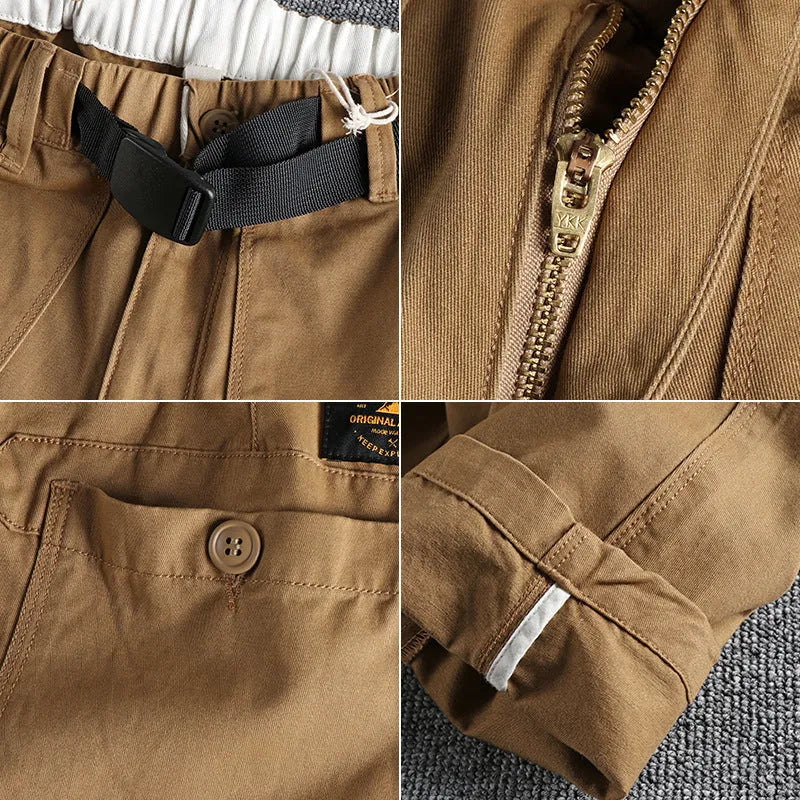 Man wearing khaki cotton work trousers with a buckle belt and structured three-dimensional cut.