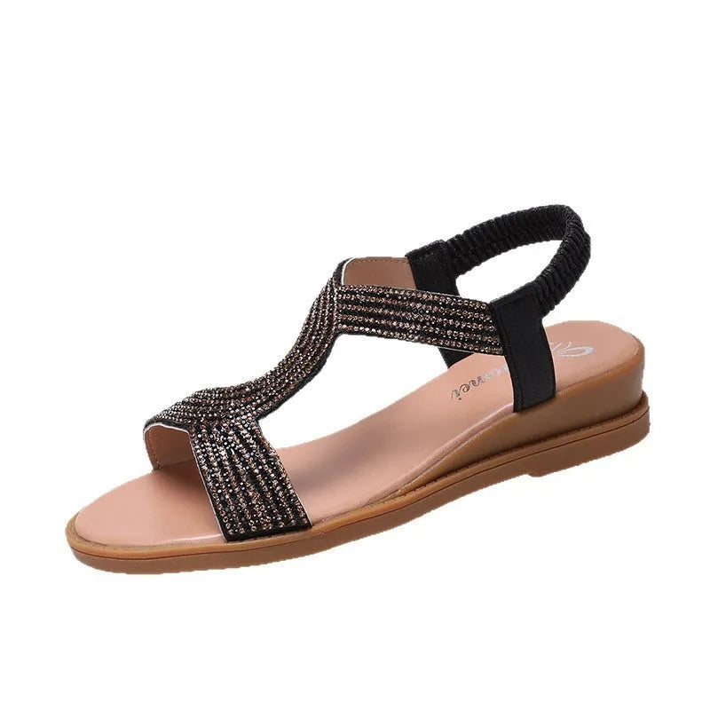Gold women's patent leather beach sandals with rhinestone decoration on the straps.