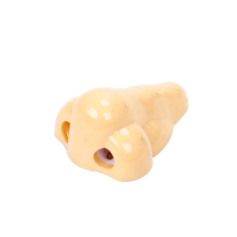 Flesh coloured plastic manual pencil sharpener with geometry shape and large nostril opening