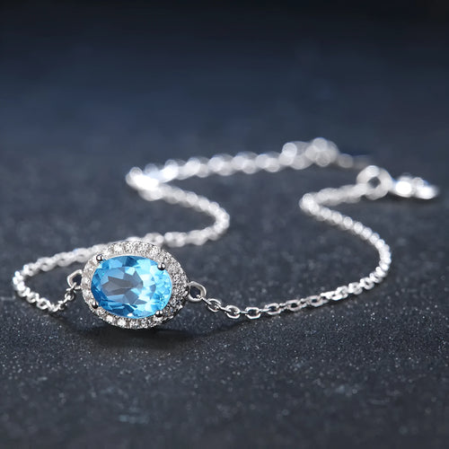 925 Sterling Silver four-piece jewellery set with Blue Topaz gemstones including earrings, ring, pendant and necklace