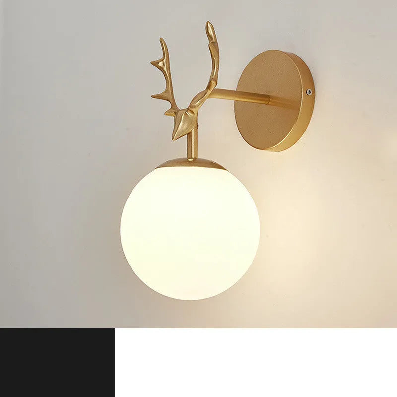 Round glass Nordic wall lamp with golden water pattern finish on a white wall.