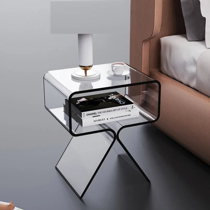 Minimalist acrylic side table in transparent black, 39x30x45cm, beside a sofa in a living room