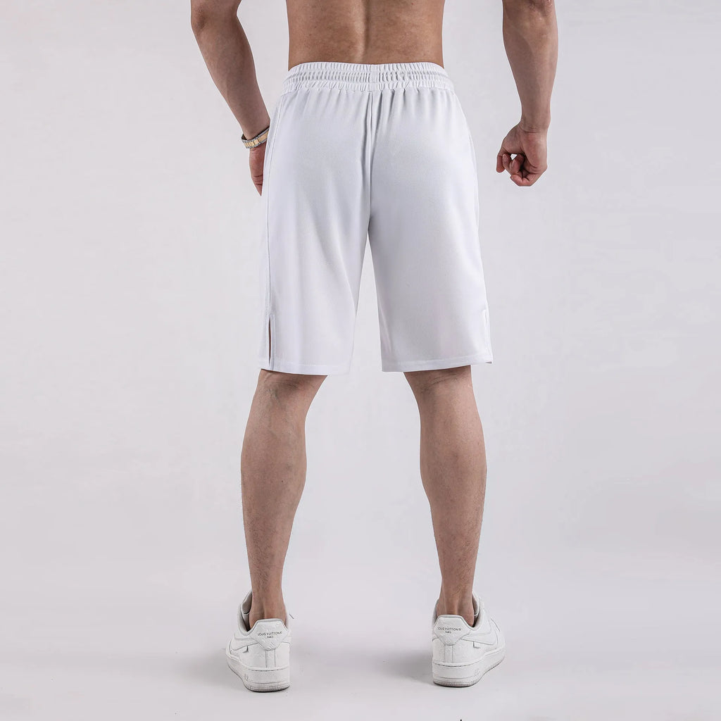 A man wearing loose-fitting black quick-dry mesh fitness shorts with an elastic waist.