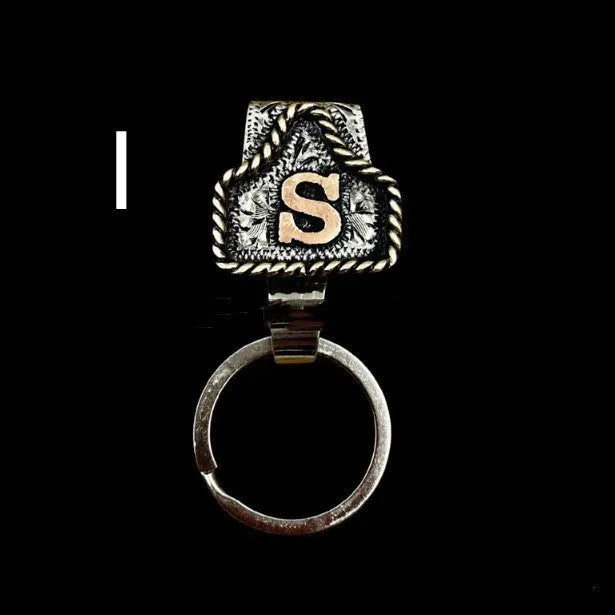 Handmade metal cow tag style key holder shown in one of its 26 colour options, attached to a keyring.