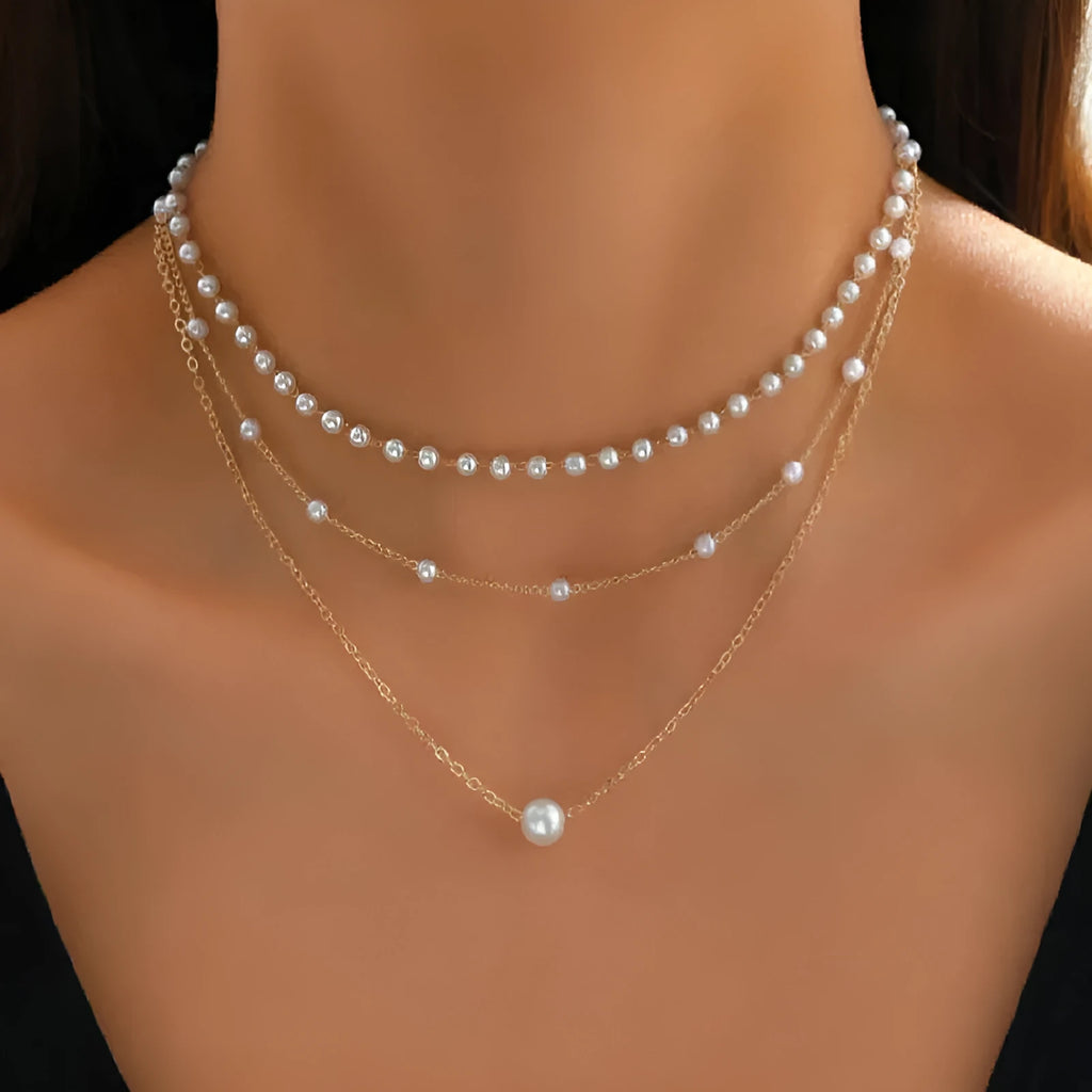 Three-layer gold imitation pearl necklace with twin pendant leaf U-shaped geometric design