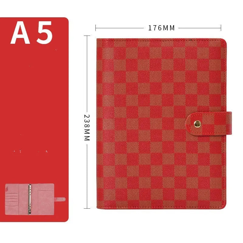 Loose-leaf notebook with imitation leather cover in A5 size, red colour, open showing ring binding and blank pages