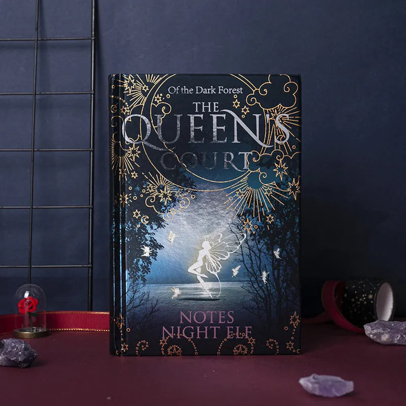 Blue A5 notebook with luminous hardcover showing night elves illustration, open to reveal full-colour printed pages
