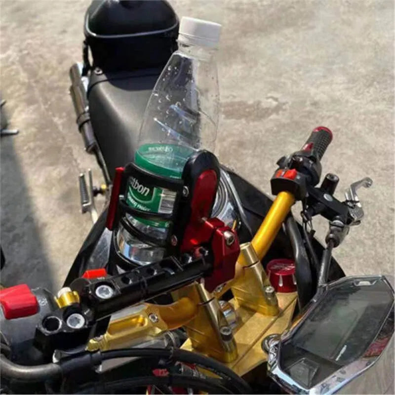 Black water bottle cage mounted on Honda scooter bumper with hydration bottle
