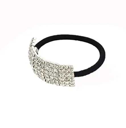 Three silver hair rings with rhinestone crystals on a light background