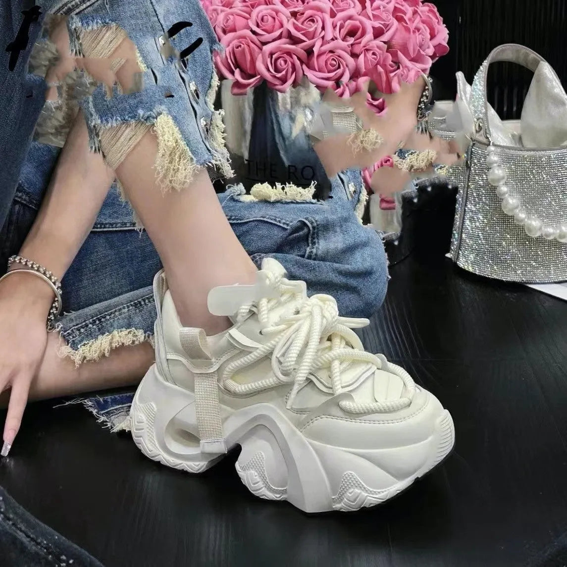 Women's creamy white wedge sneakers with cross strap detail and a thick platform sole