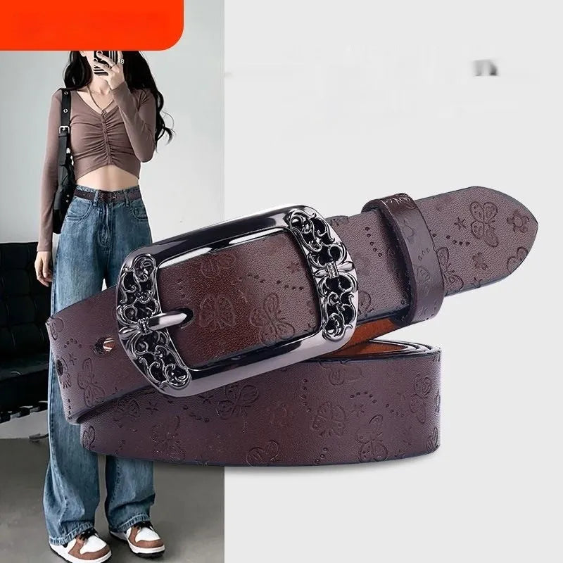 Thin black women's PU leather belt with alloy buckle fastening on jeans