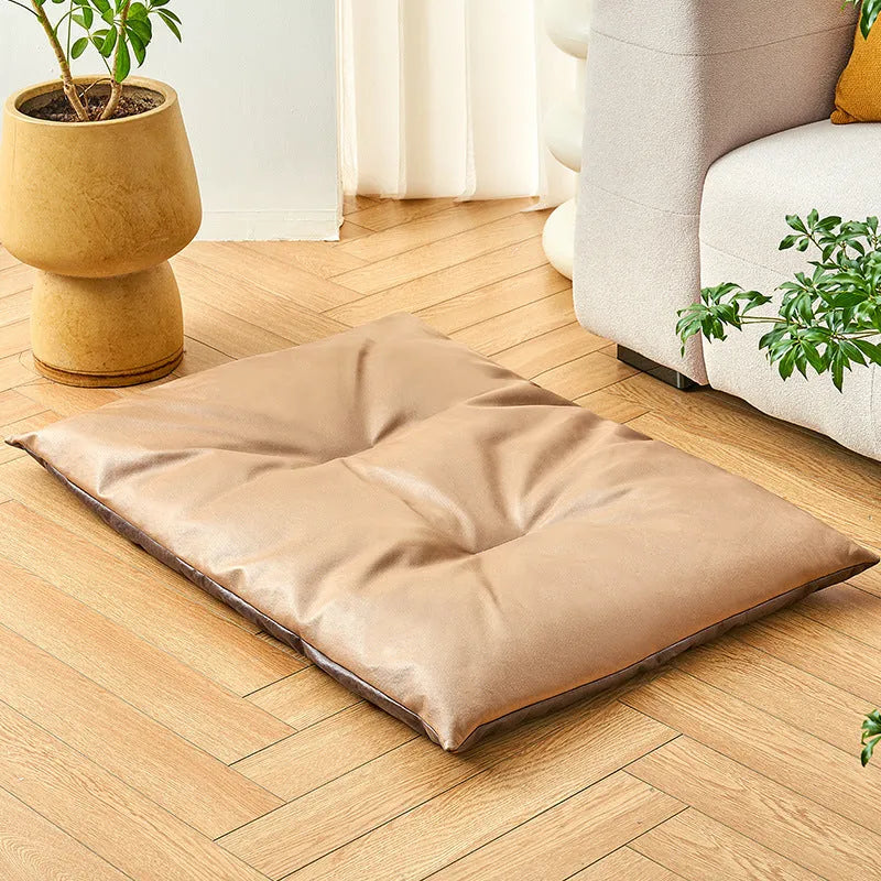 Blue plush fabric pet sleeping mat for cats or small dogs shown in a home setting.