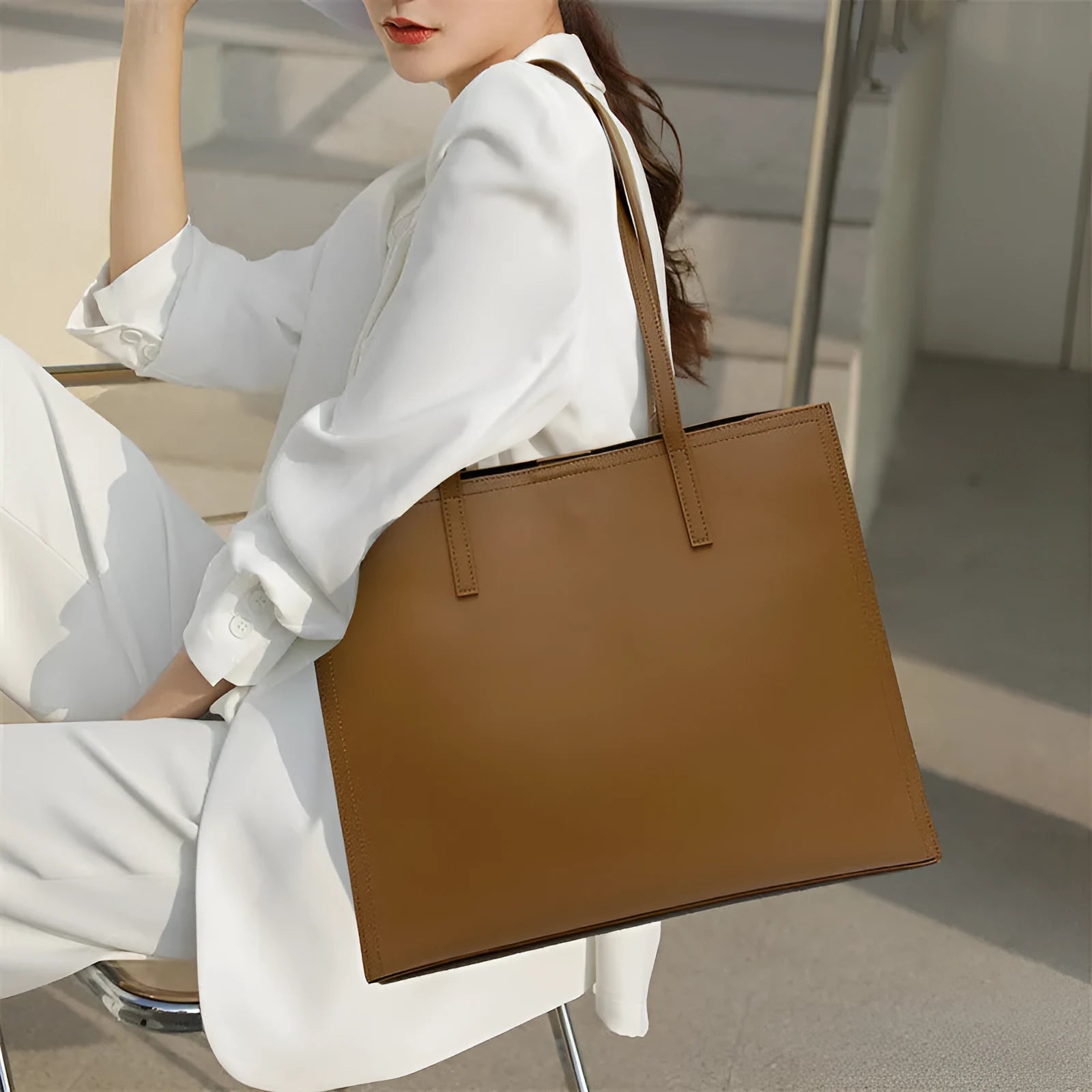 Brown genuine leather one shoulder handbag with horizontal square shape showing multiple internal compartments