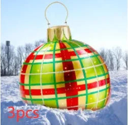 Large red and white striped inflatable Christmas ball ornament hanging on an outdoor tree