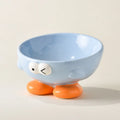 Tall blue ceramic slanted pet bowl with cute expression, designed for cervical spine support.