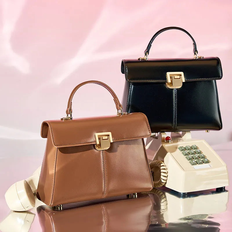 Black genuine leather women's shoulder bag with Vachette clasp closure and adjustable strap