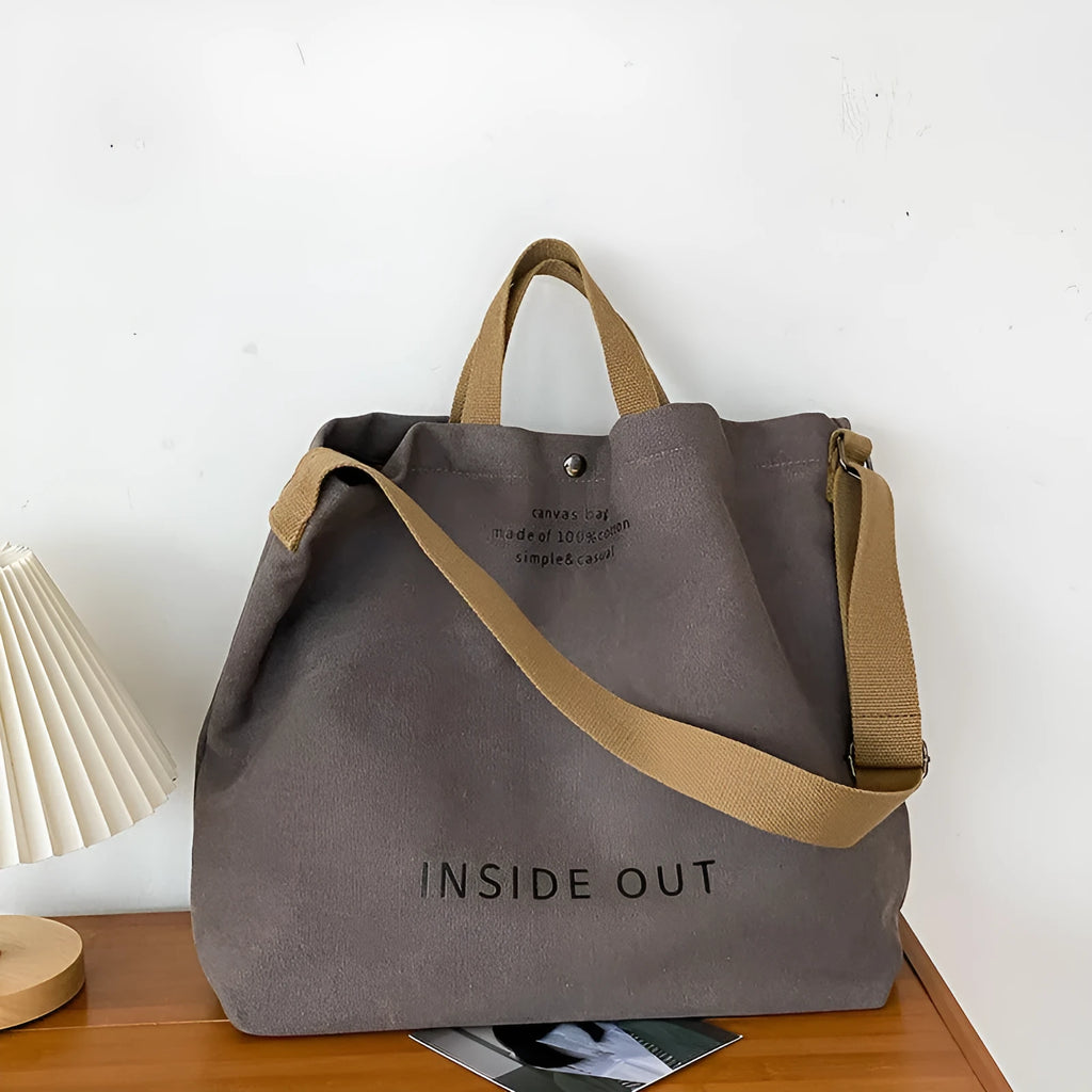 Washed canvas crossbody handbag in Army Green with horizontal square shape, outer sandwich pocket, and single strap on white background