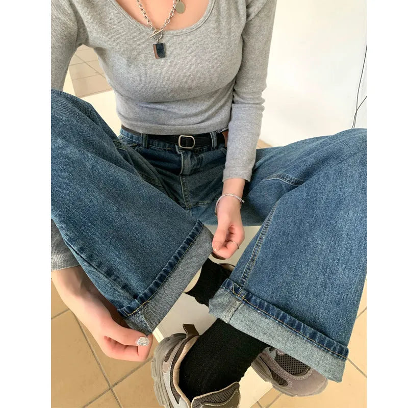 A pair of women's high waist straight leg jeans in retro blue cotton denim.