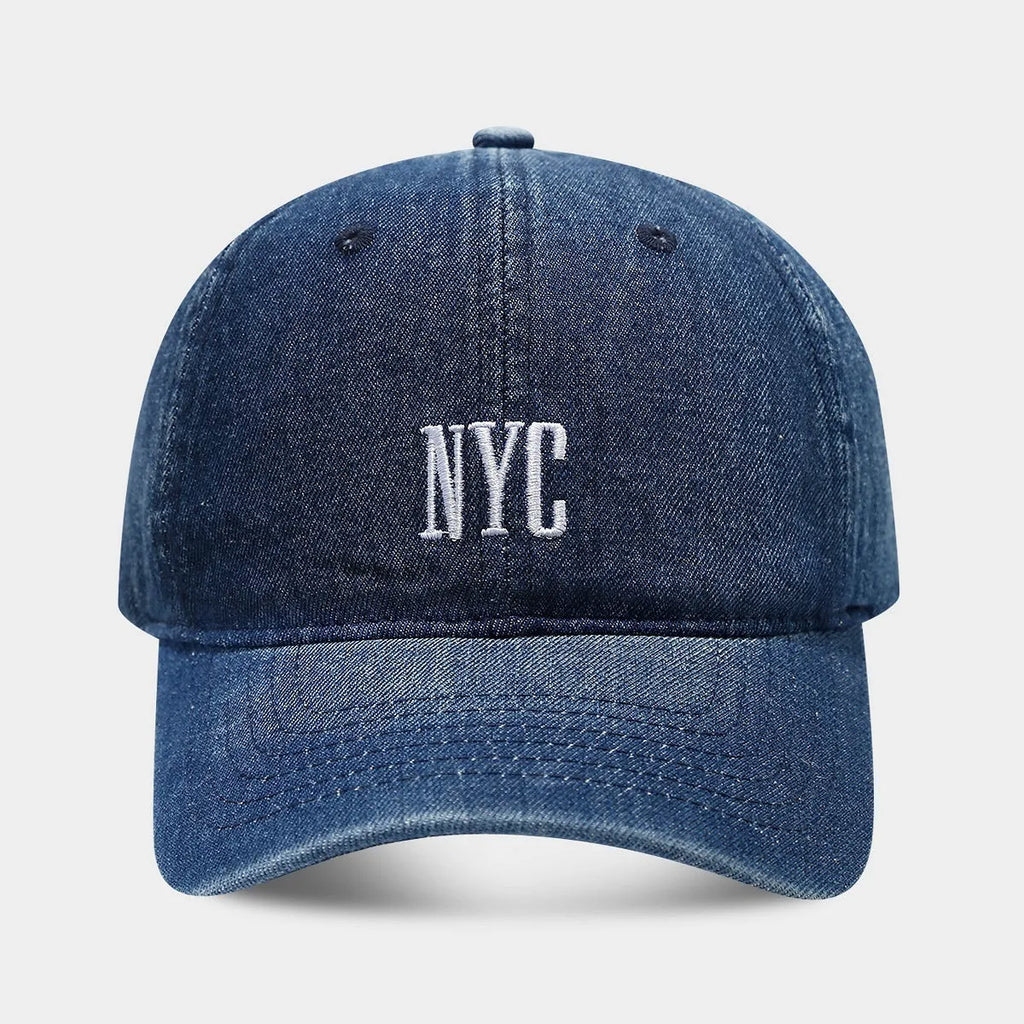 Retro denim peaked cap with embroidered letters on the front, shown in an adjustable size.