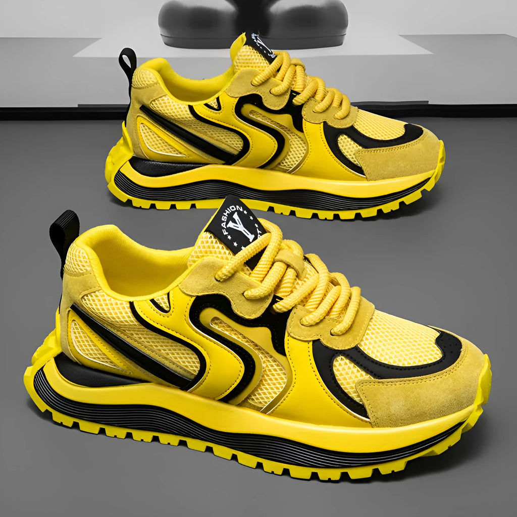 Men's yellow synthetic leather and mesh casual sneaker with rubber sole and lace-up front.