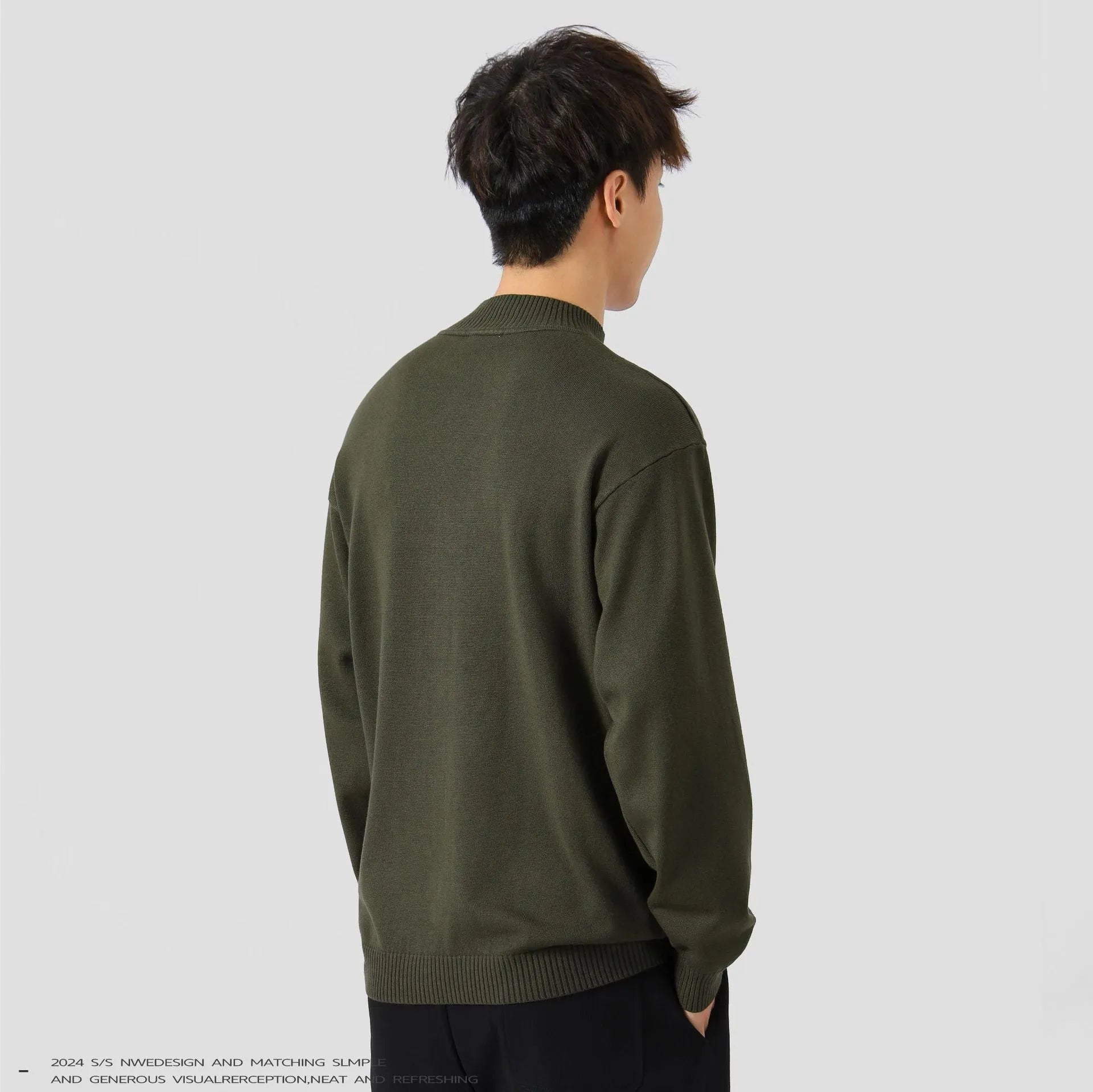 A man's loose-fitting, long-sleeve pullover sweater in a solid colour, showing a casual relaxed fit.