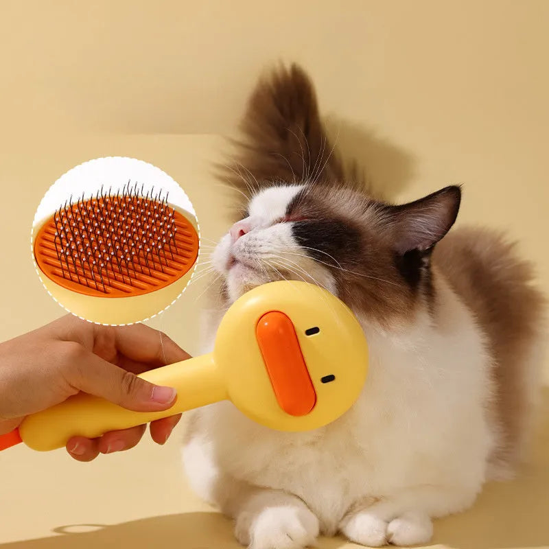 Small yellow duck-shaped pet grooming comb with open-section needle brush design for cat and dog hair removal