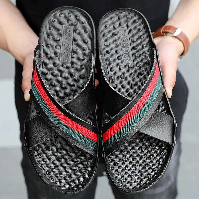 Men's blue cowhide leather flip-flops with a non-slip PU sole on a sandy beach.