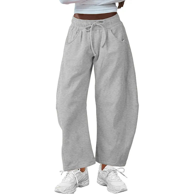 Loose cropped sweatpants with drawstring waist and side pockets in street fashion styling