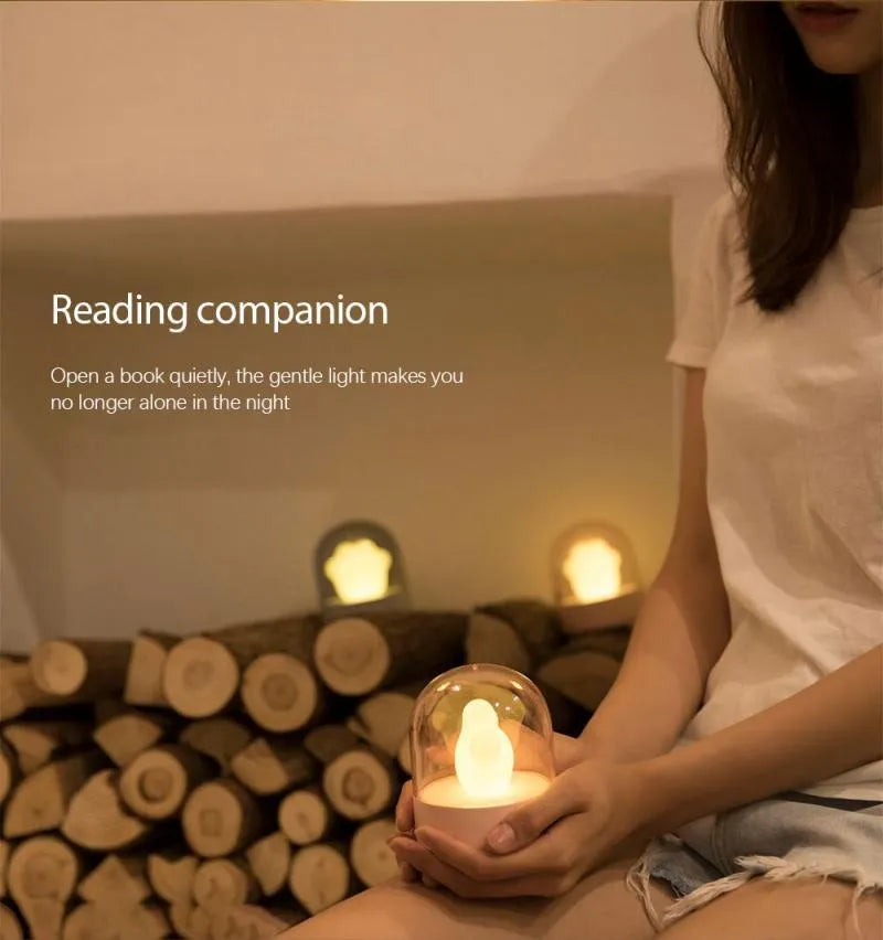 Grey cat paw shaped USB rechargeable night light with music box function on wooden desk