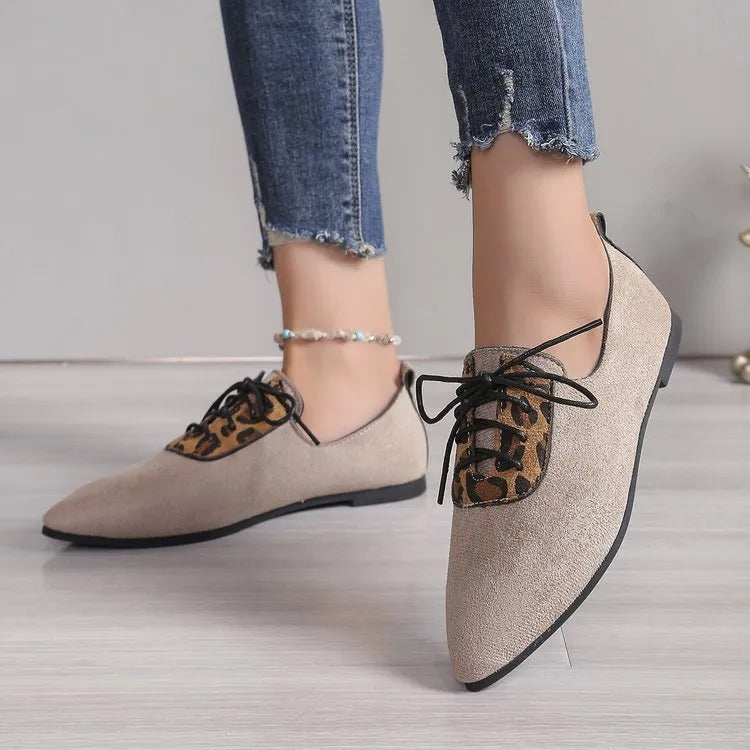 Beige leopard print women's pointed toe pumps on a white background.