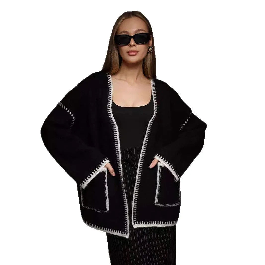 Loose black lace-up knitted cardigan sweater coat with long sleeves.