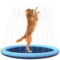 Bright blue inflatable dog splash pad with textured base, shown in a garden setting.