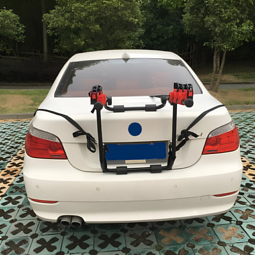 Black and red car boot mount bike rack showing iron frame with sponge padding and tie ropes.